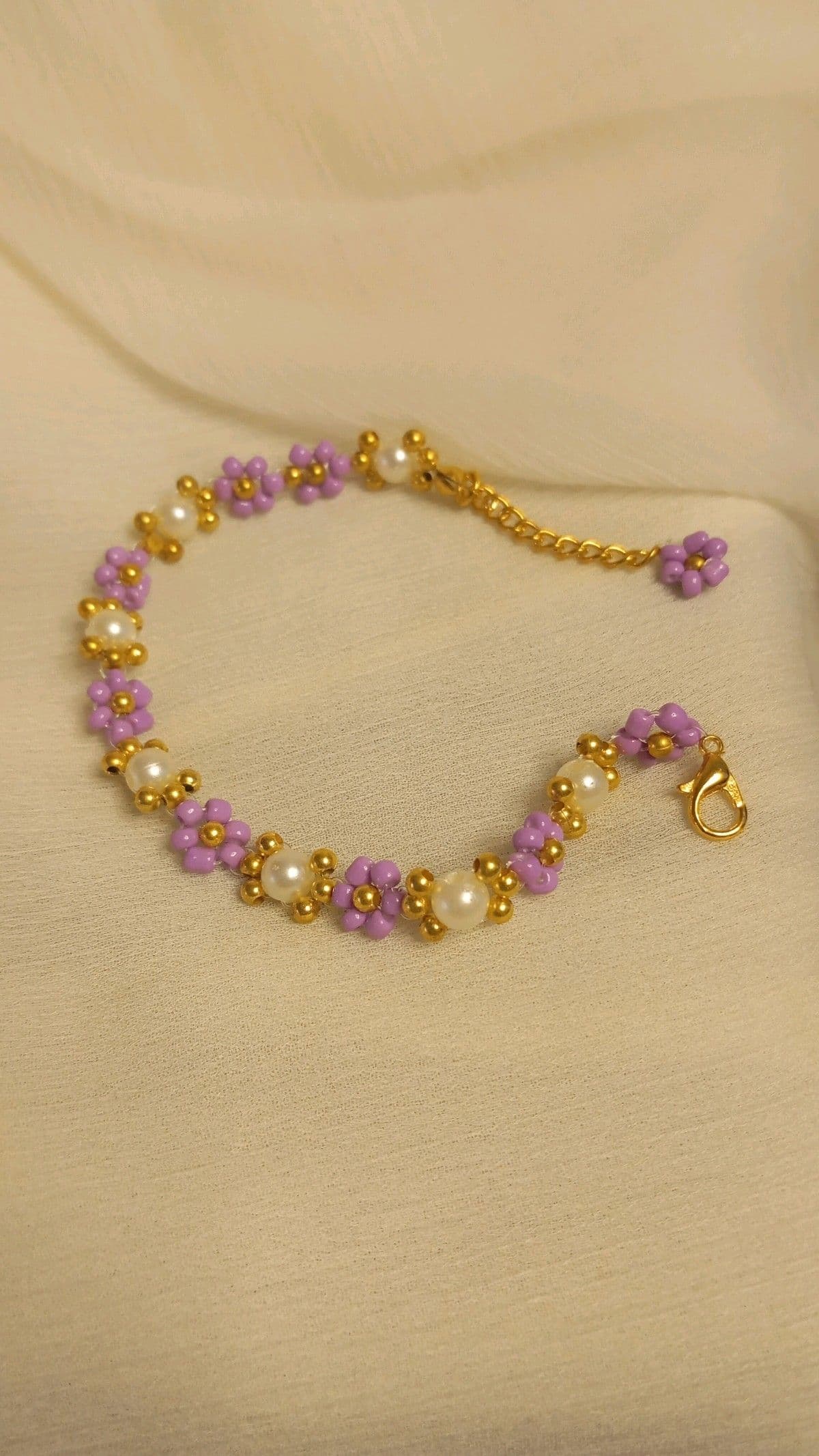 Lilac Daisy Pearl Bracelet on cream fabric